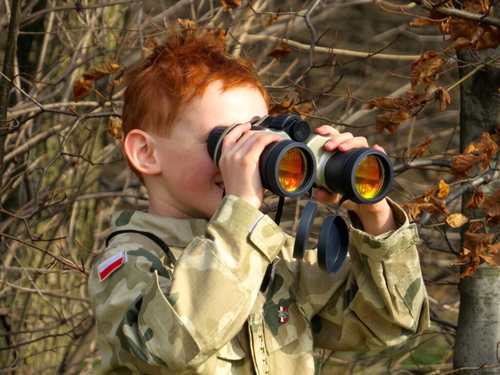 Photo of boy with binoculars playing sensory game of i-spy